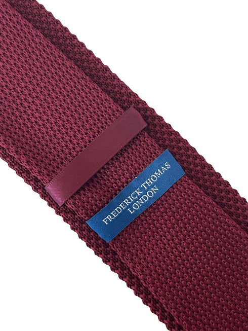 maroon knitted tie with white embroidered fleur de lis lys design